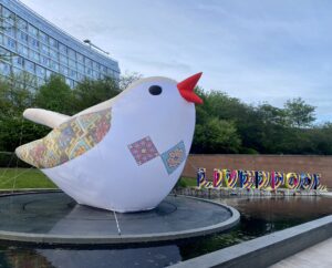 One of 'The Soloveiko Songbirds', a cultural commission, and the 'Liverpool' sign in the Eurovision colours for Eurovision 2023